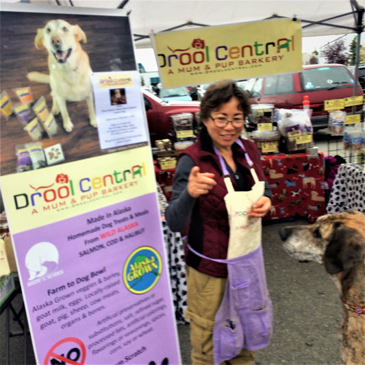 Daisy Nicolas selling dog treats at farmers market.